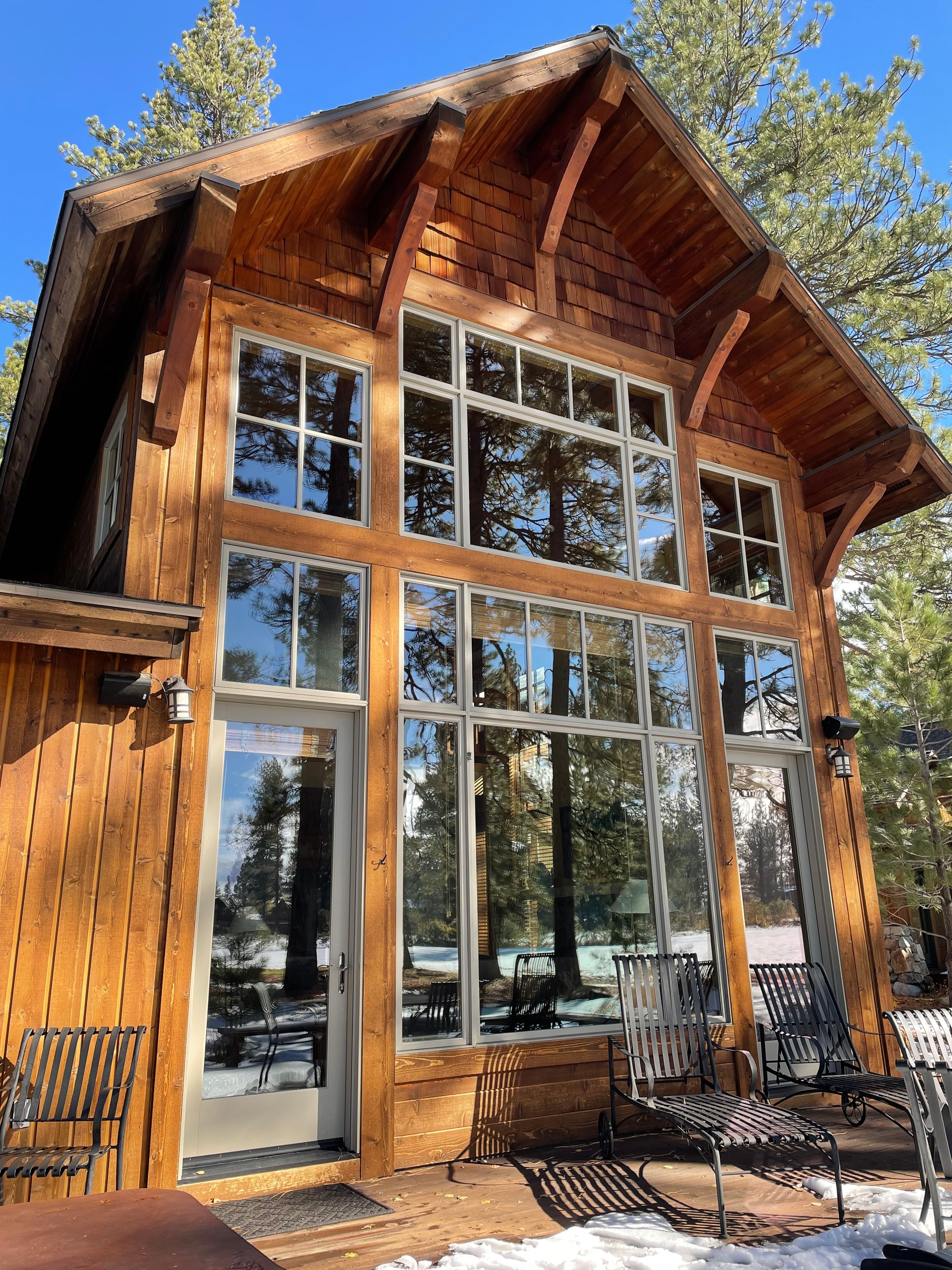 Modern wooden cabin with large forest windows
