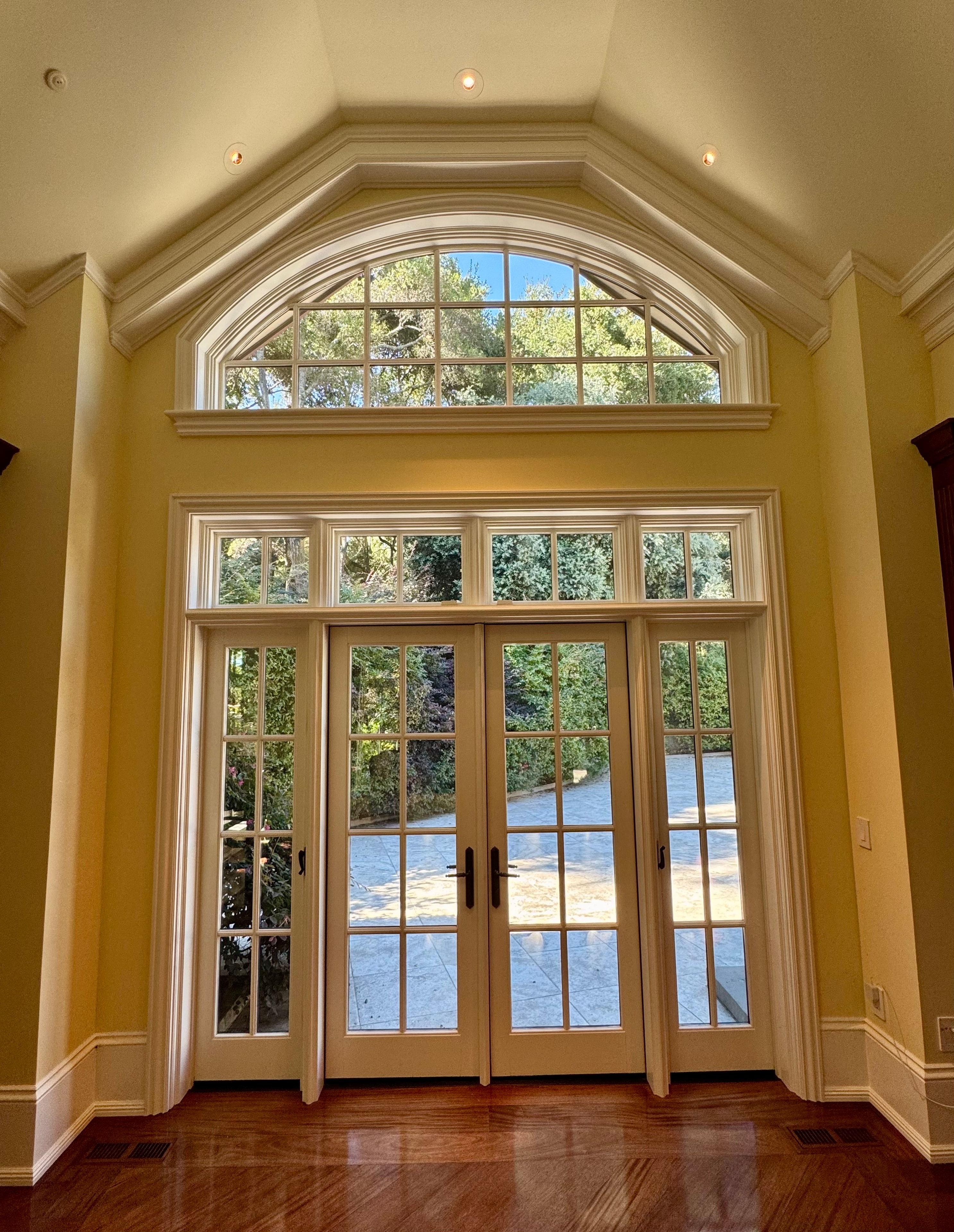 Elegant room with arched windows overlooking water